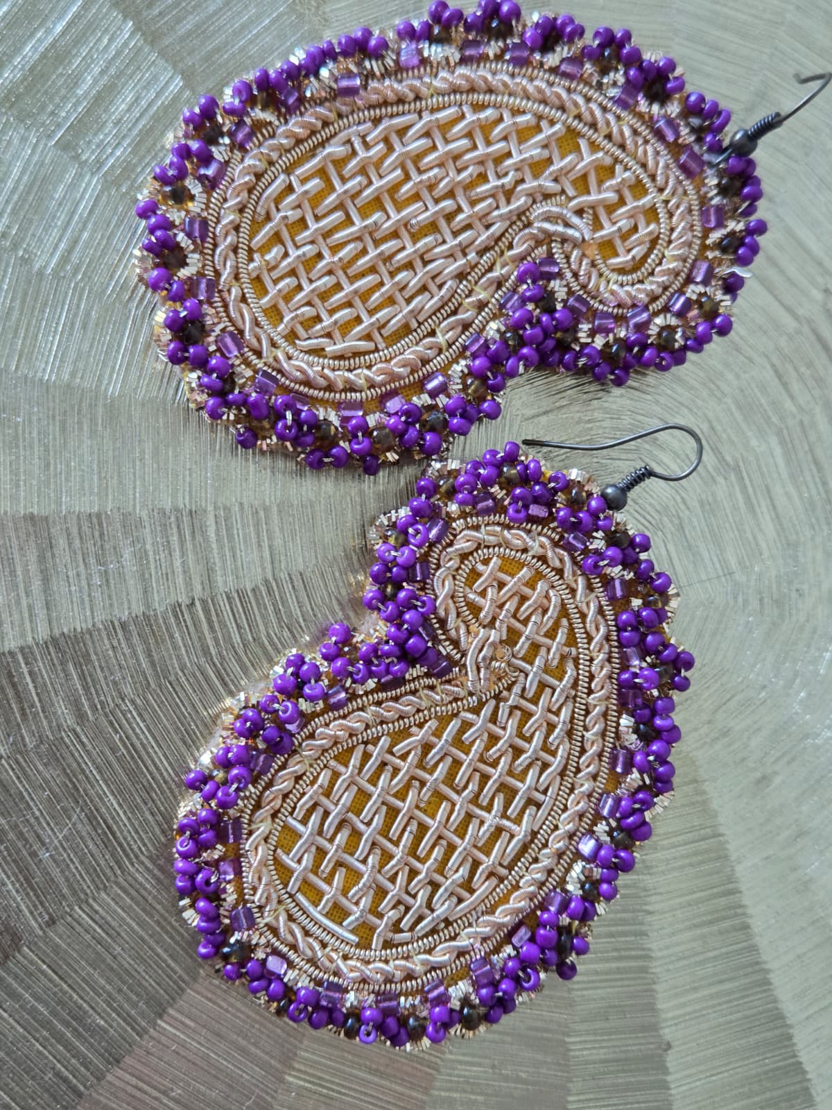 handmade earrings with golden embroidery and purple beads