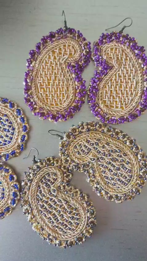handmade earrings with golden embroidery and purple beads